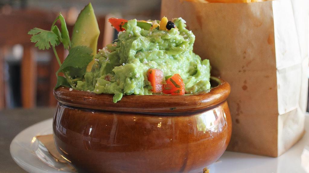 GUACAMOLE AND CHIPS · Fresh guacamole with pico, cotija and tortilla chips.