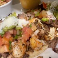 TACOS GOBERNADOR · Two big crunchy corn tortilla, wrapped in a soft corn tortilla and filled with shrimp & stea...
