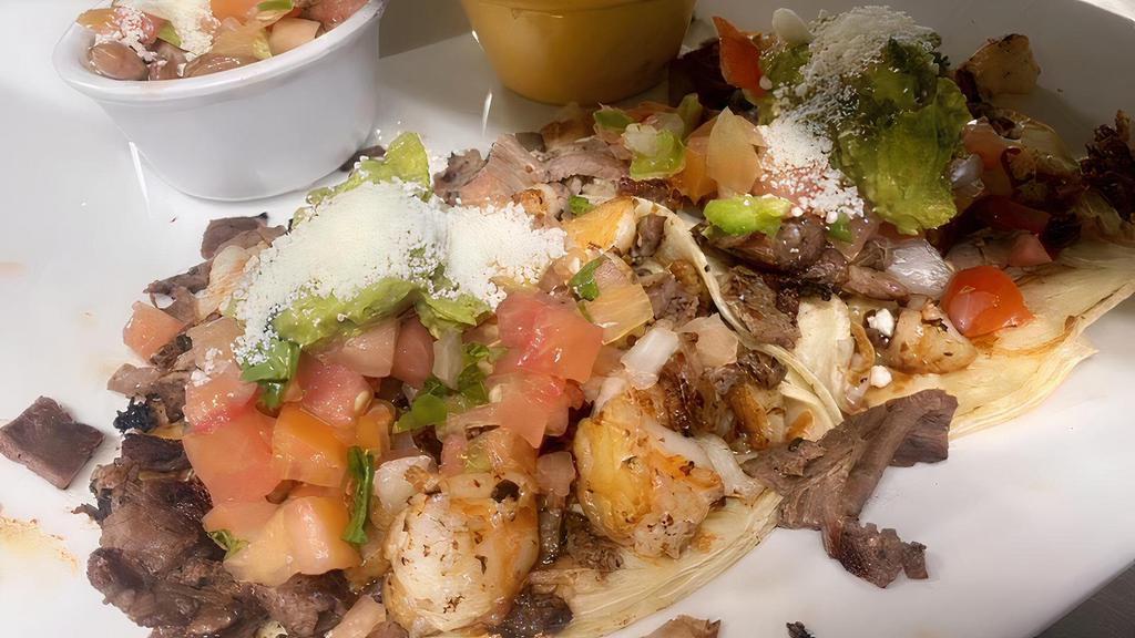 TACOS GOBERNADOR · Two big crunchy corn tortilla, wrapped in a soft corn tortilla and filled with shrimp & steak, melted Oaxaca or jack cheese, fresh avocado, pico de gallo, tomatillo salsa