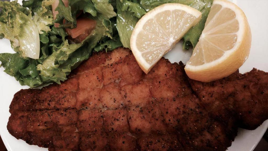 Fish Tibs · Thin slices of fillet tilapia lightly breaded and pan fried in corn oil, served with side salad and misir wot.