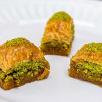 Baklava · Golden brown filo dough with a layer of pistachios. topped with syrup.