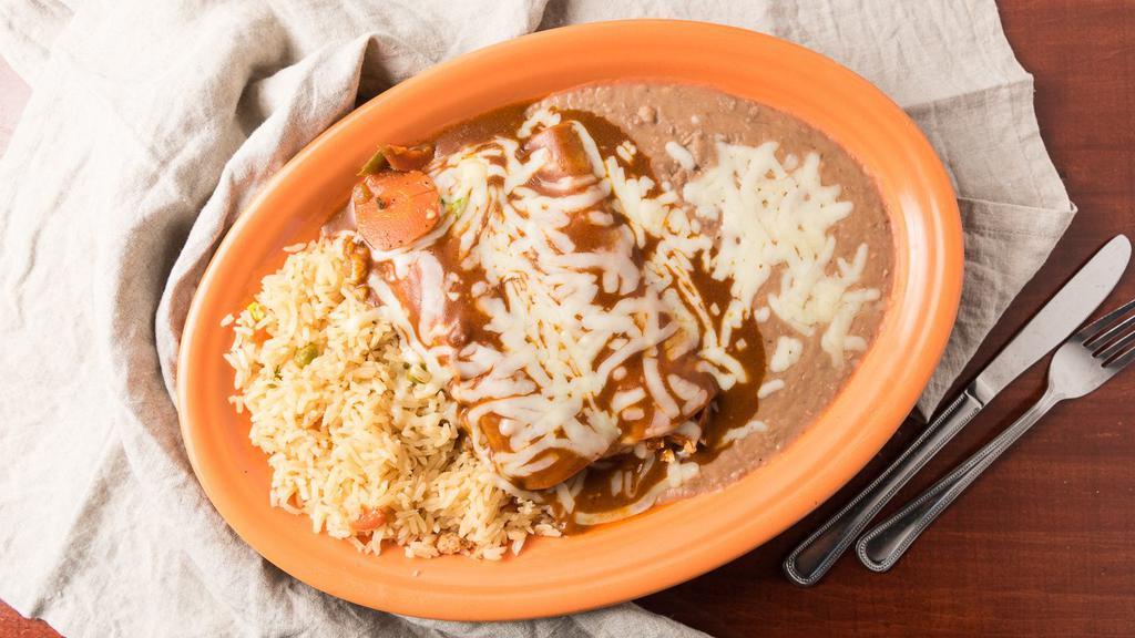 Enchiladas Dinner Entree · Served with rice and beans. Rolled corn tortilla filled with your choice of meat. Topped with our homemade red enchilada sauce and cheese.