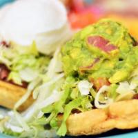 Sopes (Dinner) · Corn masa cake topped with refried beans, lettuce, sour cream, guacamole, and your choice of...