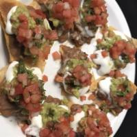 Nachos · These delicious fresh nacho chips are served with refried beans, jack and cheddar cheese, to...