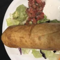 Chimichanga · This flavorful deep fried burrito is filled with savory chicken, beans and cheese, then serv...