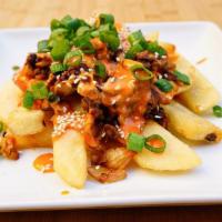 Kimchi Bulgogi fries · Steak fries topped with sautéed kimchi and bulgogi, gochujang mayo, green onions and sesame ...