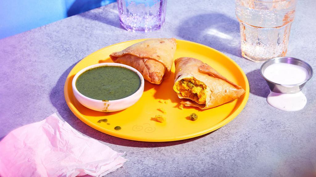 Vegetable Samosa · Golden fried pastry filled with potatoes and green peas.