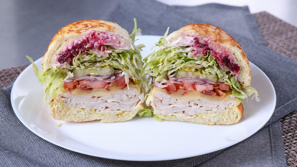 November · Turkey, thick cut bacon, white cheddar, and cranberry sauce. All sandwiches come with lettuce, tomatoes, red onions, pickles, pepperoncini, salt & pepper, house vinaigrette, and your choice of mayo and mustard.
