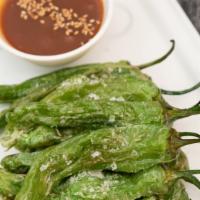 Shishito Pepper · Grilled shishito peppers tossed in our den miso sauce garnished with sesame seeds and a lemo...