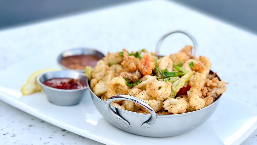 Salt & Pepper Calamari · tubes, tentacles, bell pepper and jalapeno - battered and fried with sides of sweet chili sauce and signature spicy cocktail sauce