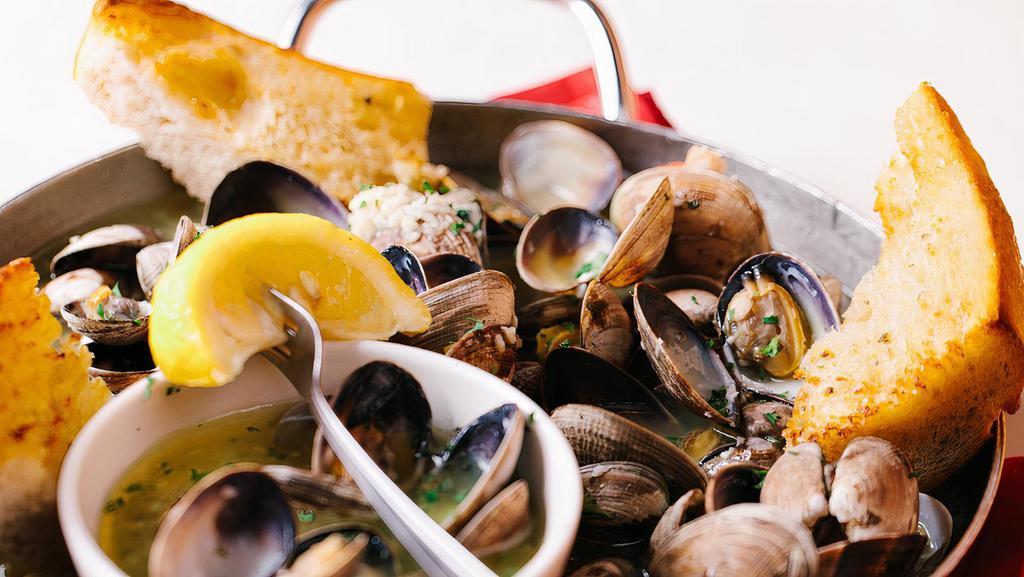 Steamed West Coast Clams · 14 oz steamed with white wine, butter, fresh garlic; served with garlic bread