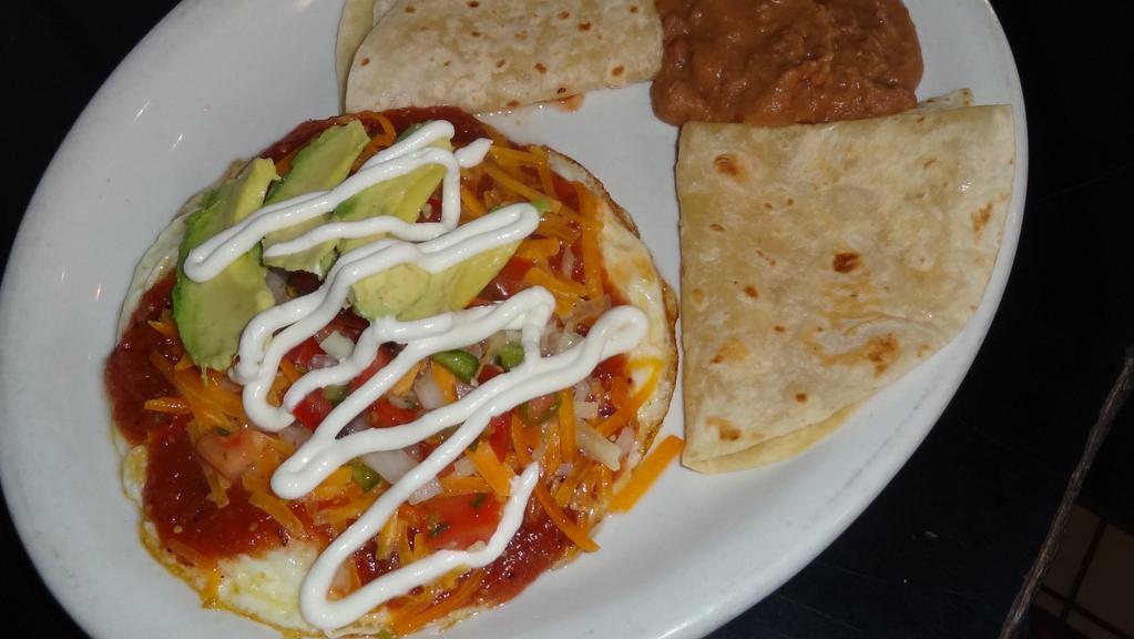 Huevos Rancheros · Three eggs simmered in salsa, served with refried beans, sour cream, avocado and tortillas.