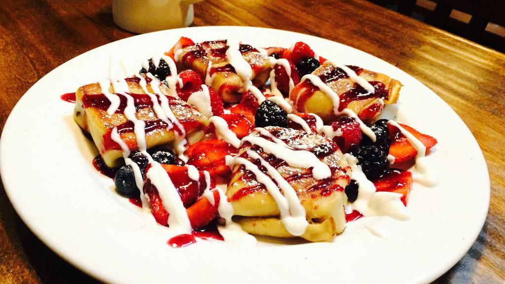 Blintzes with Fresh Berries · Our own special ricotta cheese filled blintzes, crepes covered with fresh berries, with raspberry sauce and chantilly sauce.