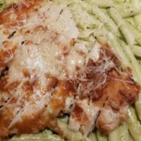 Chicken Pesto · Penne pasta with creamy pesto sauce and Parmesan cheese, topped with a breast of chicken enc...