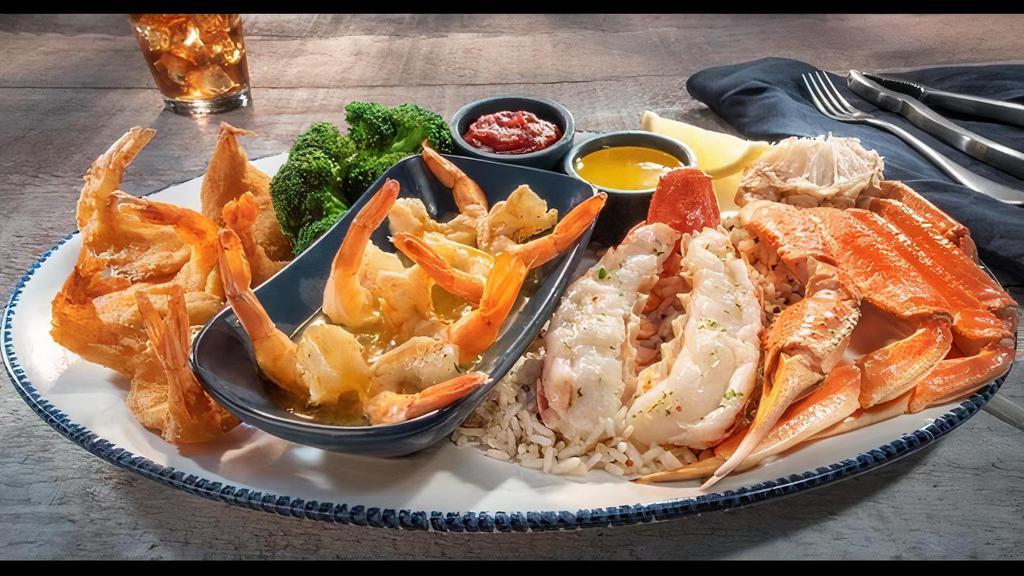 Ultimate Feast® · Tender Maine lobster tail, wild-caught North American snow crab legs, our signature hand-crafted garlic shrimp scampi and Walt's Favorite Shrimp. Served with melted butter, lemon, cocktail sauce and choice of two sides.. 1070 Cal
