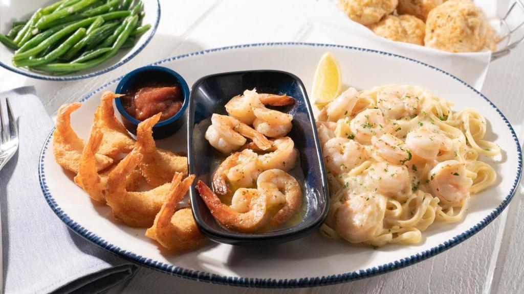 Seaside Shrimp Trio · A generous sampling of Walt's Favorite Shrimp, hand-crafted garlic shrimp scampi and creamy shrimp linguini Alfredo. Served with lemon, cocktail sauce and choice of two sides.. 1500 Cal