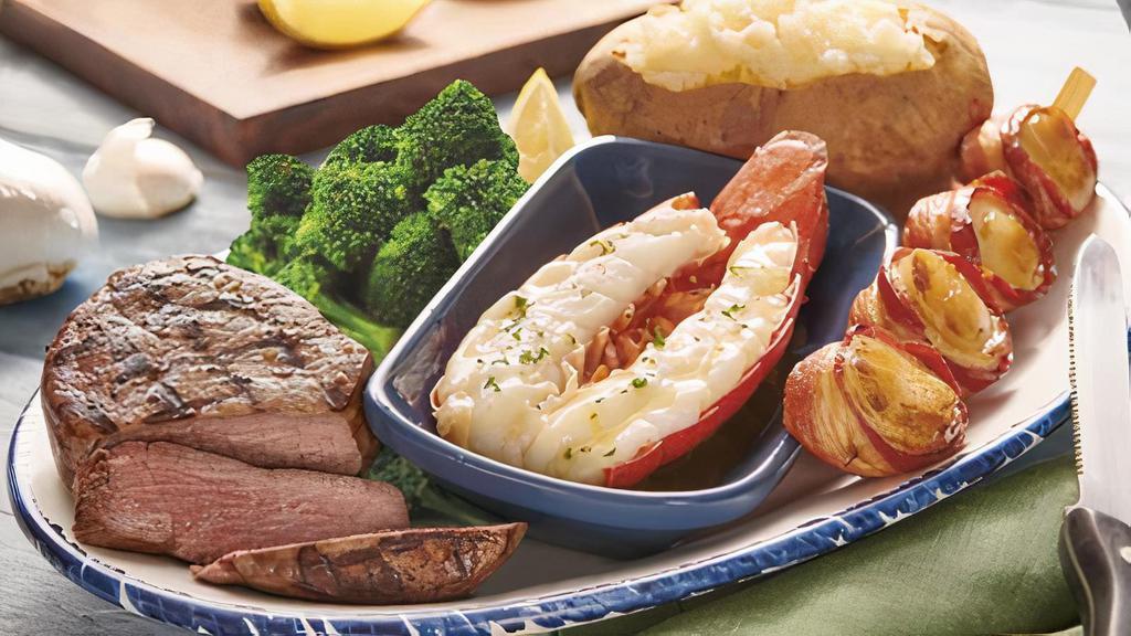Ultimate Surf & Turf** · A 6 oz. filet mignon**, butter-poached Maine lobster tail and bacon-wrapped sea scallops. Served with lemon and choice of two sides.. 850 Cal
