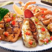 Lobster, Shrimp And Salmon** · A Maine lobster tail, jumbo shrimp skewer and fresh Atlantic salmon finished with a brown bu...