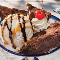 Brownie Overboard® · Warm brownie wedges served with a scoop of vanilla ice cream. Topped with caramel, fudge, an...