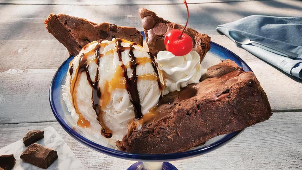 Brownie Overboard® · Warm brownie wedges served with a scoop of vanilla ice cream. Topped with caramel, fudge, and whipped cream.. 1020 Cal