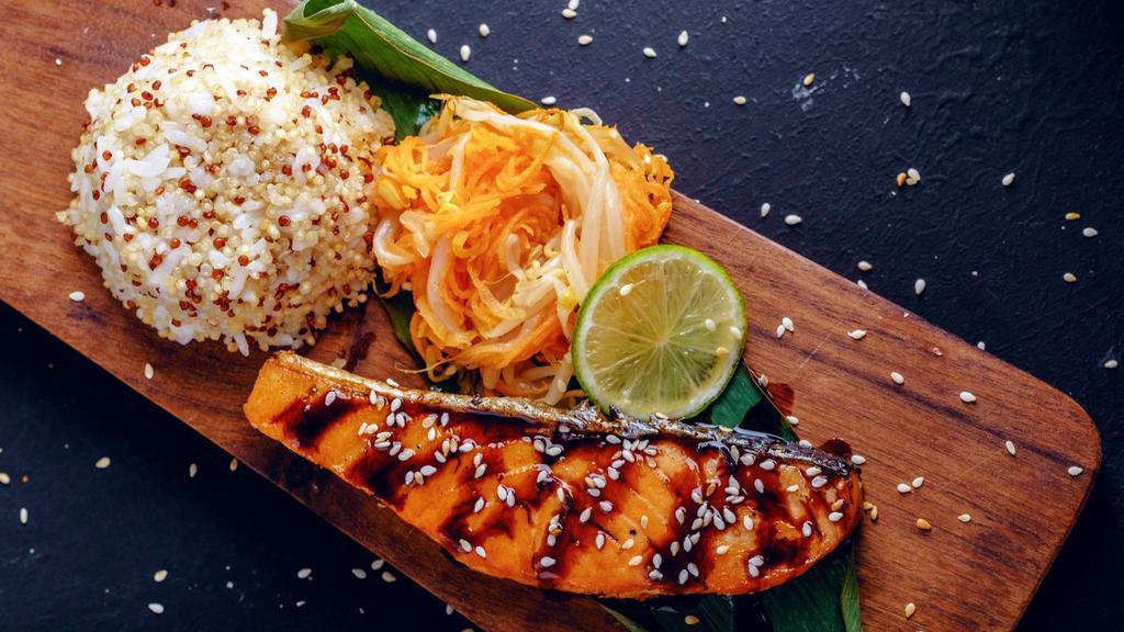 Salmon Teriyaki · Mouthwatering grilled Salmon topped with Teriyaki sauce and served with a side of rice and salad.