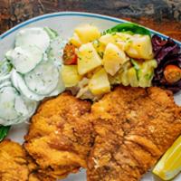Classic Wiener Schnitzel · Classic wiener schnitzel - thin, breaded, pan-fried veal cutlet, potato salad, and creamy cu...