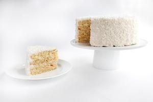 Tropical Coconut Cake · Vanilla cake layered with pineapple accented coconut filling & topped with fluffy coconut bu...