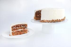 Carrot Cake · Baked with pecans & golden raisins, layered with our unique “praline filling” & topped with traditional cream cheese frosting.