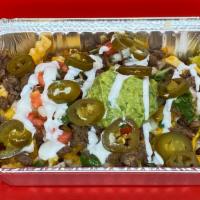 Asada Fries · Large portion of french fries drenched in nacho cheese with sour cream, guacamole and pico d...