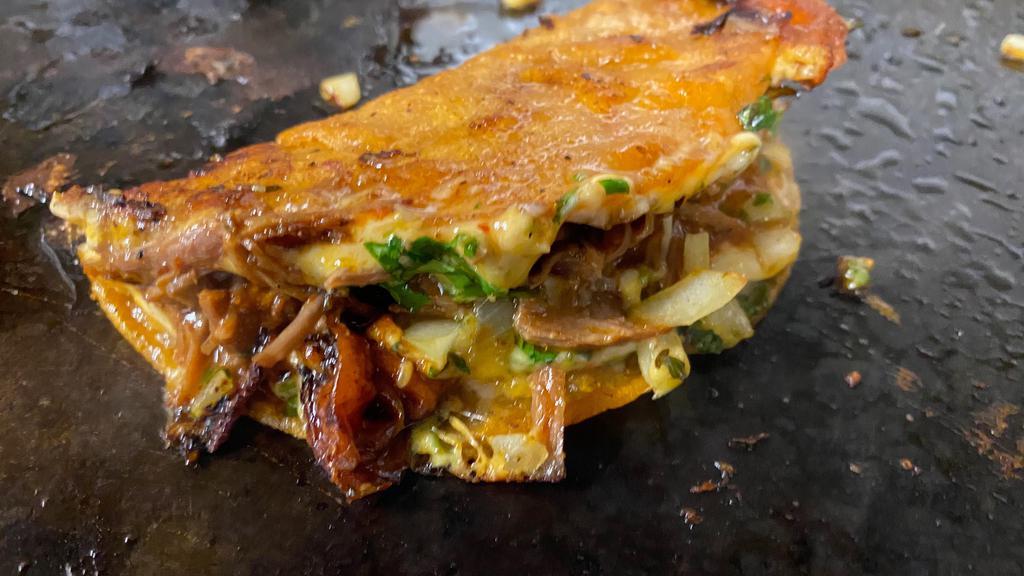 Quesabirria · A new trendy item the quesabirria now popular in the bay area. A semi crisp tortilla with melted cheese, birria (shredded beef) and onions and cilantro.