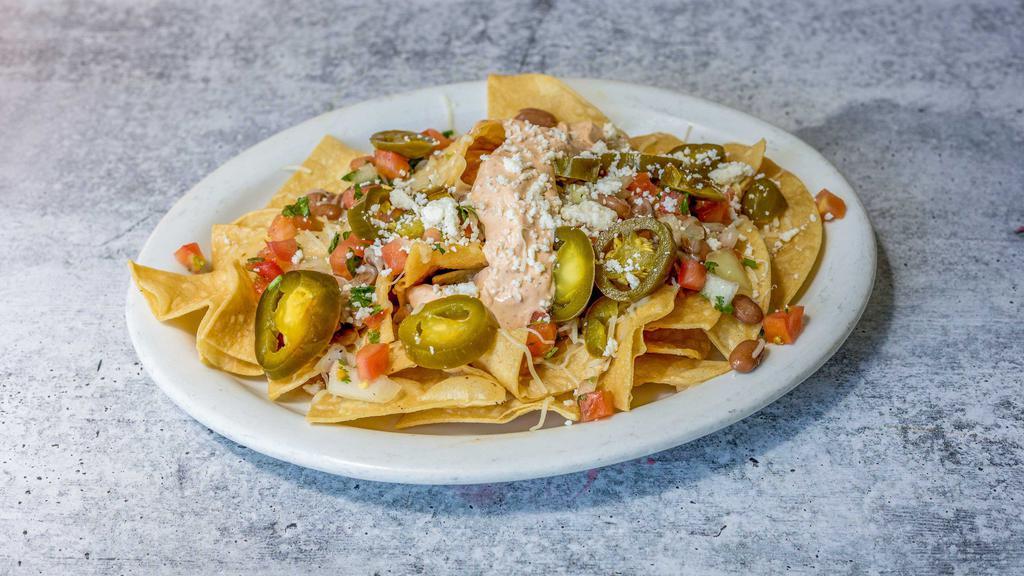 Talavera Nachos · Homemade corn chips, melted Jack cheese and queso fresco, choice of beans, jalapeños, salsa fresca and sour cream. Add meat or guacamole for an additional charge.