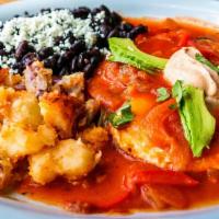 Huevos Rancheros · Two over easy eggs topped with a red chile ancho sauce, avocado, sour cream potatoes, choice...