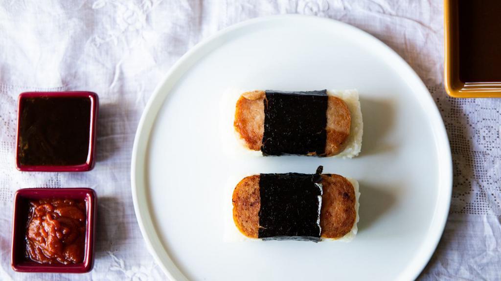 Portuguese Sausage Musubi · A block of rice with your choice of meat wrapped in dried seaweed.