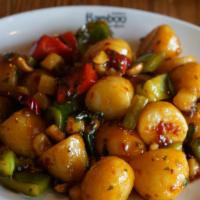 Kung Pao Potatoes · Vegan. Spicy. Baby potatoes, bell peppers, water chestnut, peanuts, dry red chili.