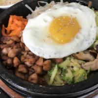 Bibimbab / 비빔밥 · Assorted beef or vegetable with fried egg over rice. Served with four side dishes.