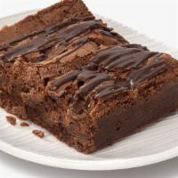 Indulgent Chocolate Brownie · Traditional chocolate decadence  with chocolate chips bits throughout and striped on top.