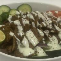 Lamb Bowl · Grilled lamb gyro served over seasoned basmati rice, topped with our veggie mix, tzatziki, a...