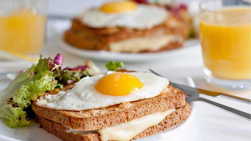 2 Eggs with Melted Cheese on Toast · 