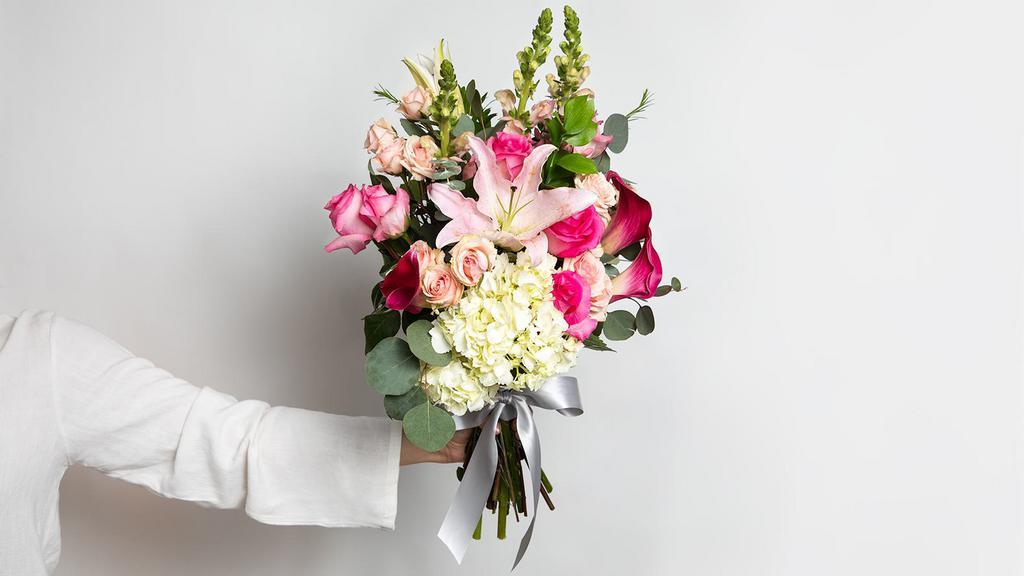 Pleasantly Pink Medium Bouquet · Roses, mini callas, spray roses, snap dragons, lilies, hydrangeas, fillers and greens.