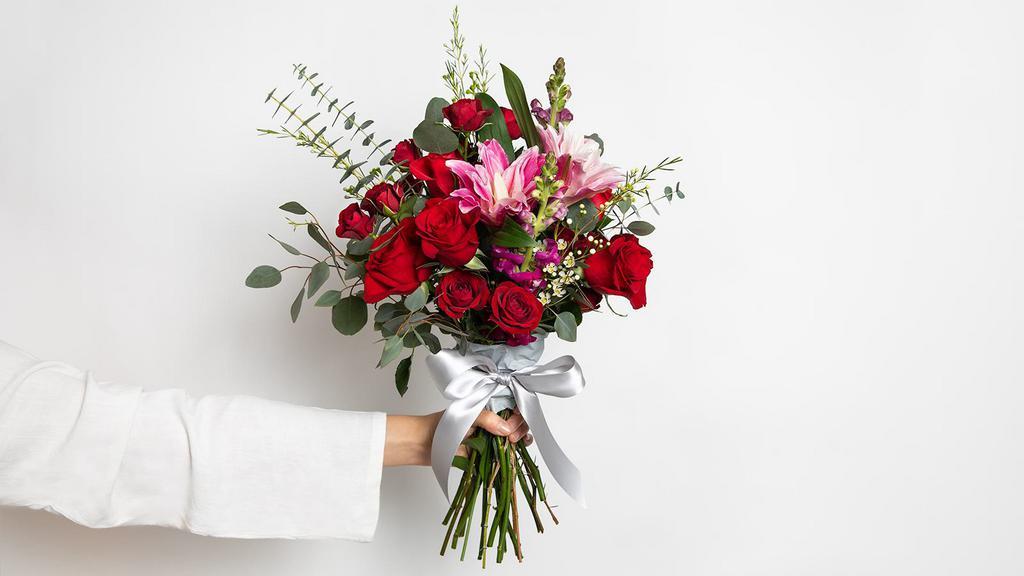 Rosey Red Medium Bouquet · Roses, double lilies, spray roses, snapdragons, fillers and greens.