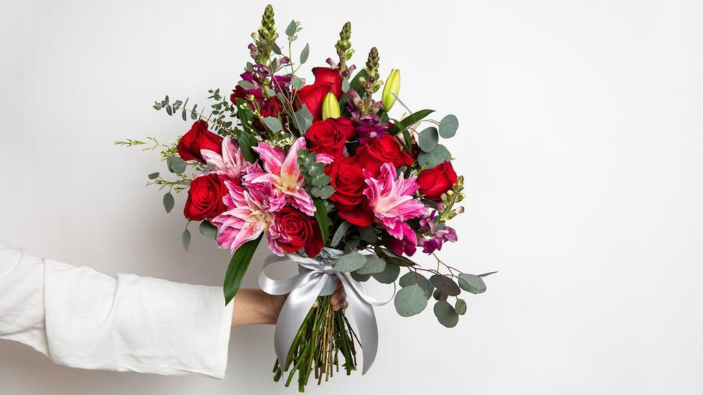 Rosey Red Large Bouquet · Roses, double lilies, snapdragons, spray roses, fillers and greens.