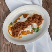 Kadoo · Baked baby pumpkin seasoned with sugar and topped with ground beef sauce.