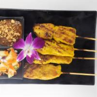 Chicken Satay · Chicken on skewers marinated with variety of Thai herbs served with cucumber salad and homem...