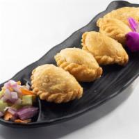 Thai Samosa (Vegan) · Fried wheat roll stuffed with sautéed golden potatoes, onions and curry powder, served with ...