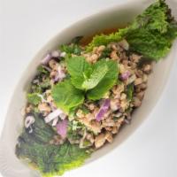 Larb Gai (Chicken Salad) · Gluten free. Medium spicy. Minced chicken with red onions, roasted rice powder, cilantro, an...