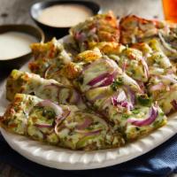 Pesto Sticks · Cheesy pesto bread-sticks topped with red onions and green chill.