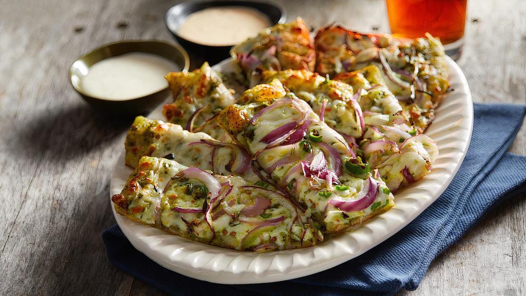 Pesto Sticks · Cheesy pesto bread-sticks topped with red onions and green chill.