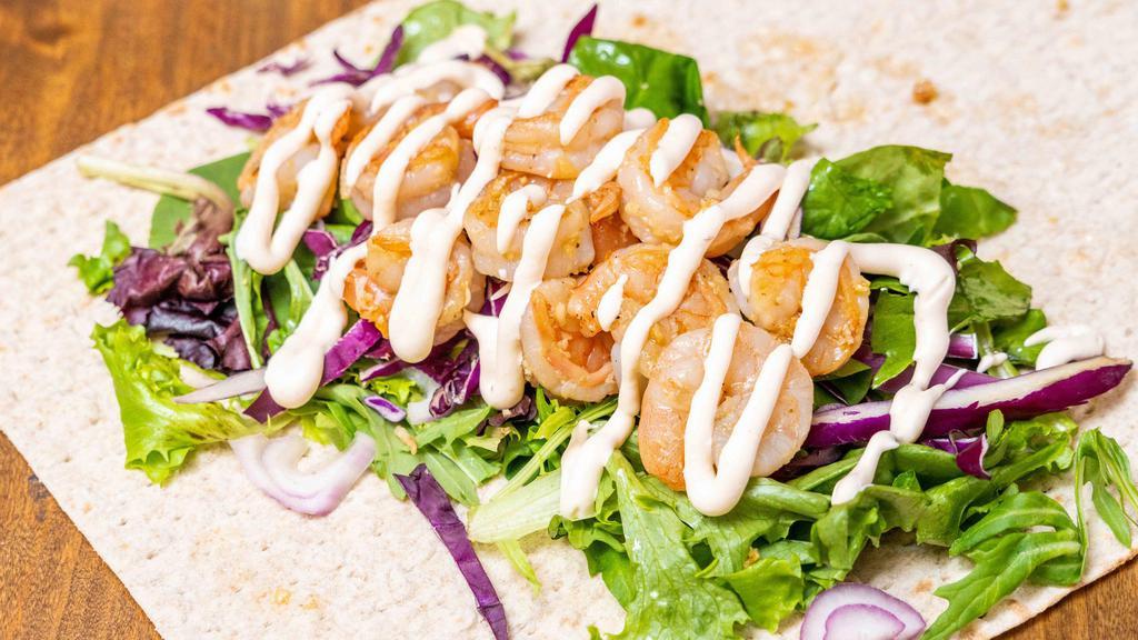 Shrimp Wrap · House marinated shrimp with lettuce, red cabbage, sliced red onion, garlic, lime crema and cilantro.