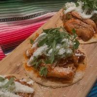 Tinga de Pollo Tacos · chipotle braised chicken, guacamole, cortija, crema mexicana