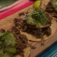 Carnitas Tacos · braised pork shank, Spanish white onions, salsa verde de aguacate